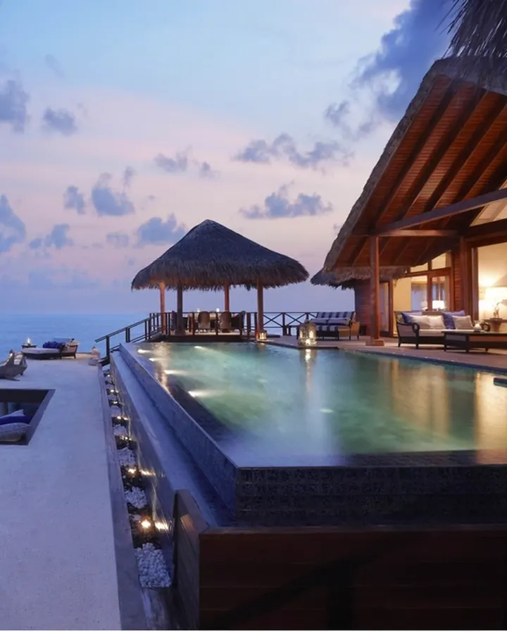Infinity pool at a beach villa at dusk